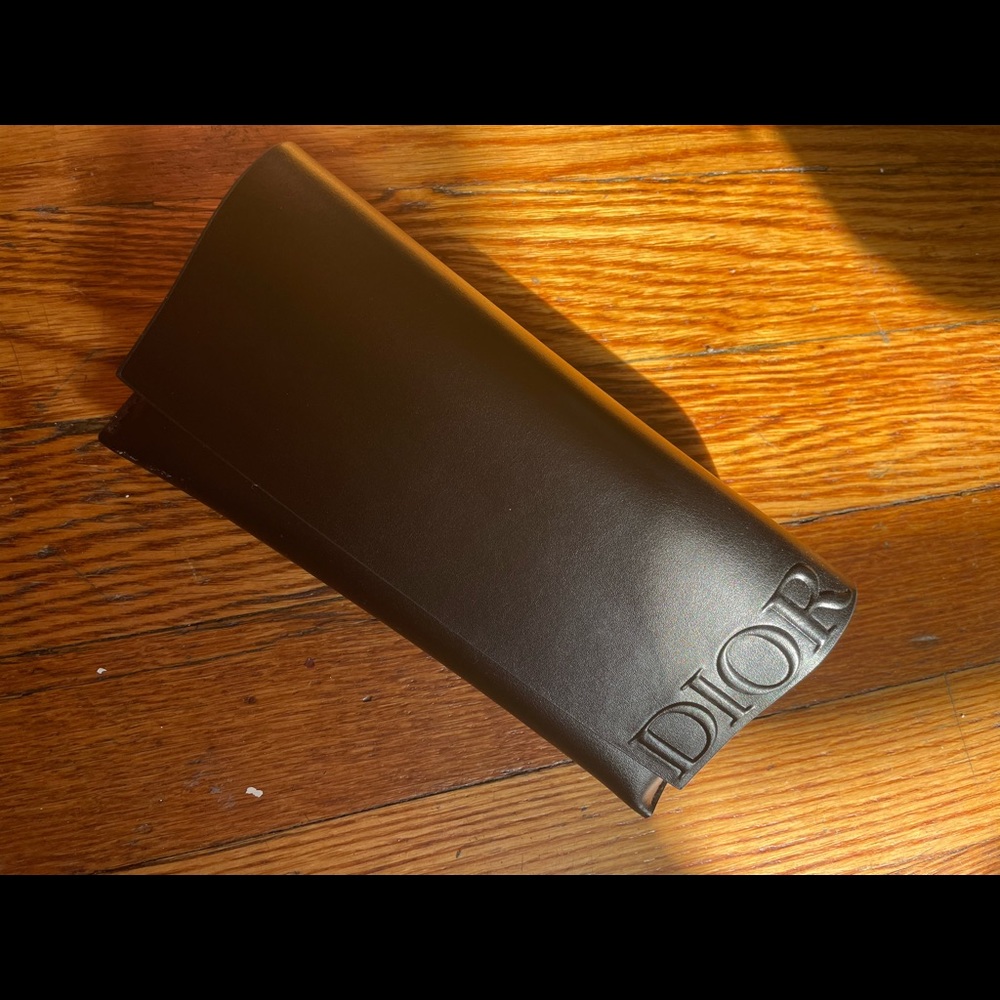 Dior glasses holder with belt attachment.